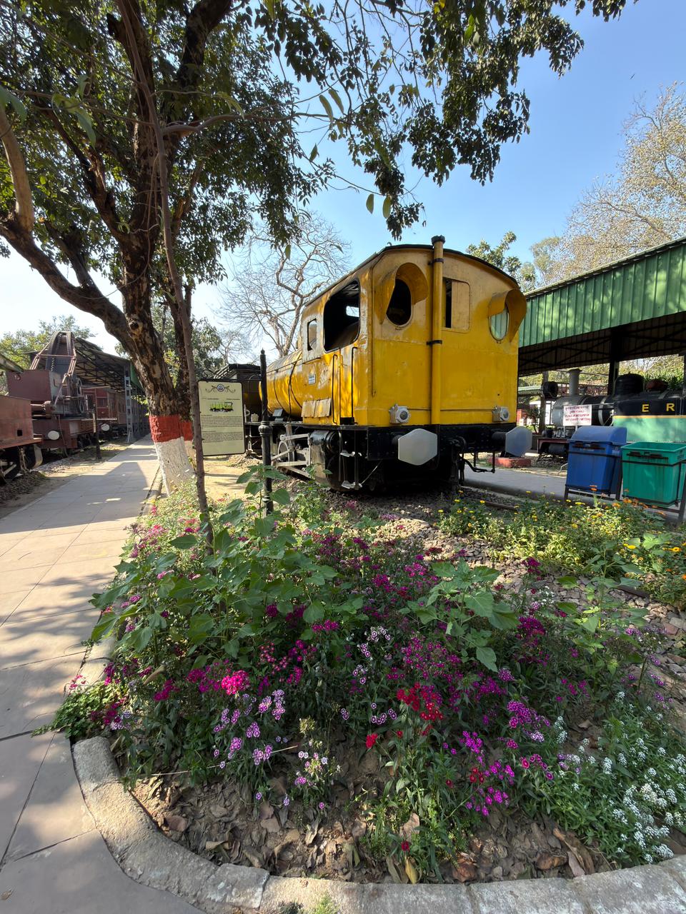 Rail exhibit framed by maintained planting at National Rail Museum